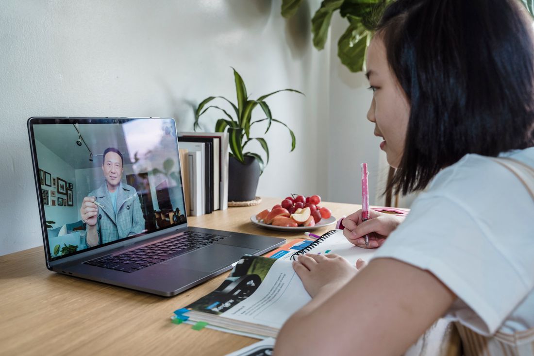 A student attending an online class on a laptop